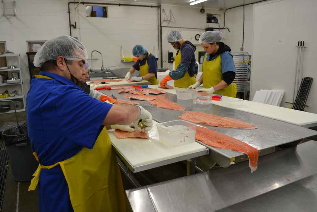 Staff prepping salmon 