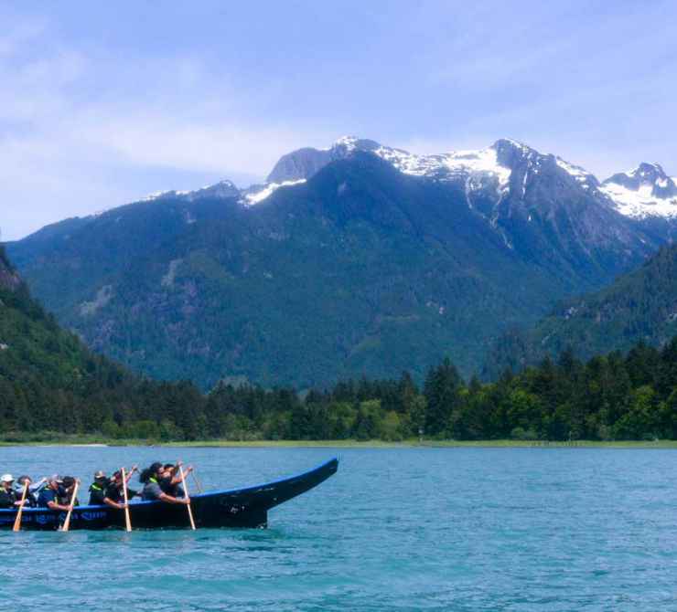 Homalco tour guides greet visitors in a welcome canoe in Bute Inlet. Photo by Tricia Tomas.