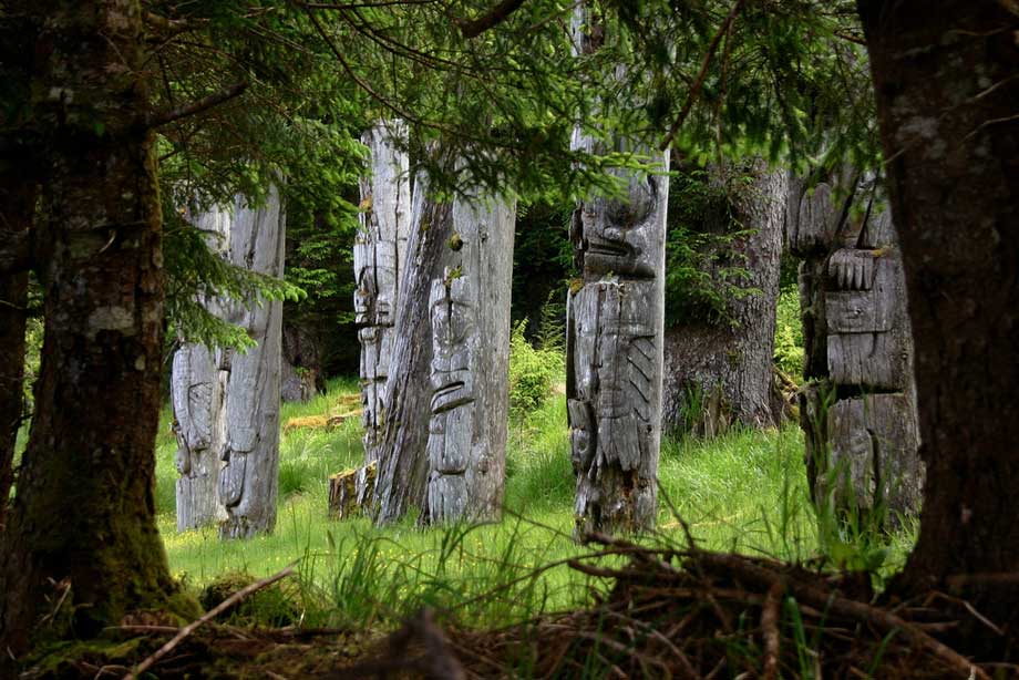 Ancient Haida totems at SGang Gwaay Llnagaay, Gwaii Haanas National Park, Haida Gwaii. This area is now protected because of the stand at Lyell Island. Photo by <a href="http://www.brodieguy.com/">Brodie Guy</a>.