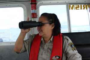 Gitga'at Guardian Mary Reece looking for humpback whales while on patrol. Photo by Meaghan Hume. 