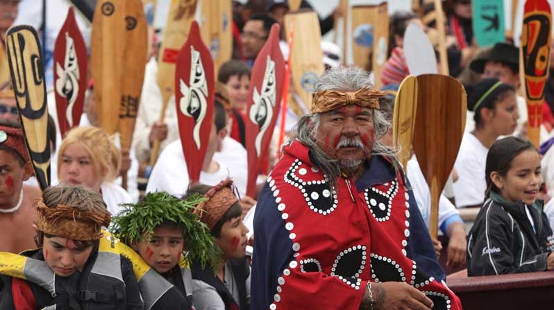 Members of <a href="https://coastfunds.ca/first-nations/heiltsuk-nation/">Heiltsuk</a> celebrate a Tribal Canoe Journey. Photo by Darryl Dyck, courtesy of The Canadian Press.