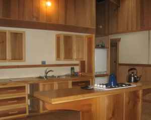 Longhouses feature custom-designed cabinetry and furnishings made by members of the carpentry crew with locally harvested and milled lumber.