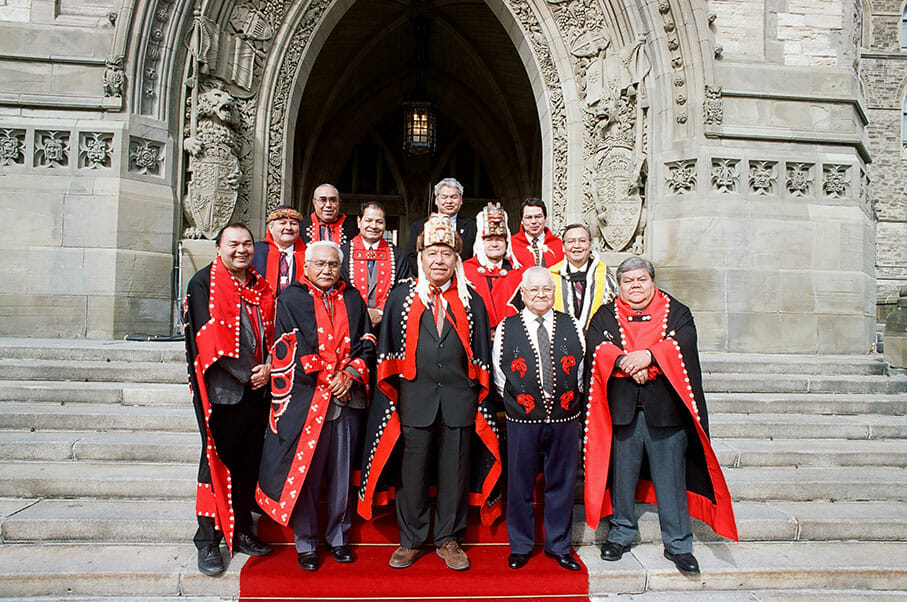 Nisg̱a’a chiefs and members of the treaty negotiating team outside the entrance to the parliament building in Ottawa. Photo by Gary Fiegehen, Courtesy of Nisga’a Lisims Government.