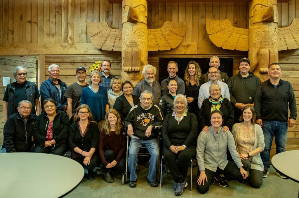 Hilistis <em>Pauline Waterfall</em> (second row, far right) with Coast Funds board of directors and staff alongside Haíɫzaqv Hemas (Hereditary Chiefs) and Elders in June 2019. Photo by Coast Funds.