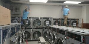 workers install new lighting and laundry machines