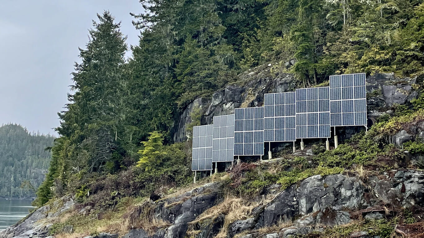 solar panels placed vertically on the top of an oceanside cliff