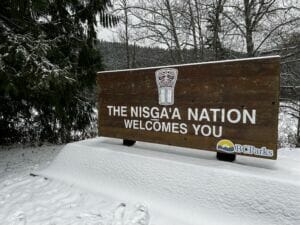 sign saying "the Nisg̱a’a Nation welcomes you" on a snowy day