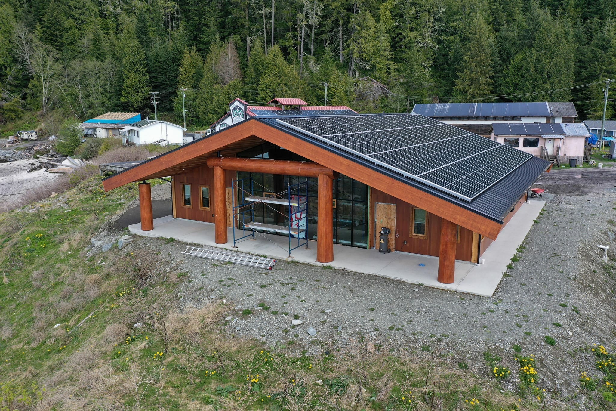 aerial photo of a new wood-frame building topped with solar panels