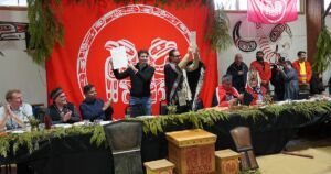 Council of the Haida Nation President Gaagwiis and Prime Minister Justin Trudeau holding up the signed Chiixuujin | Chaaw Kaawgaa Agreement. (Photo: Rhea Botel / Council of the Haida Nation)