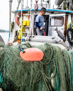 An up-close glimpse of one of the tools of the trade: a spooled net aboard a fishing boat, prepared for the next catch. (Photo: Troy Moth / Coast Funds)