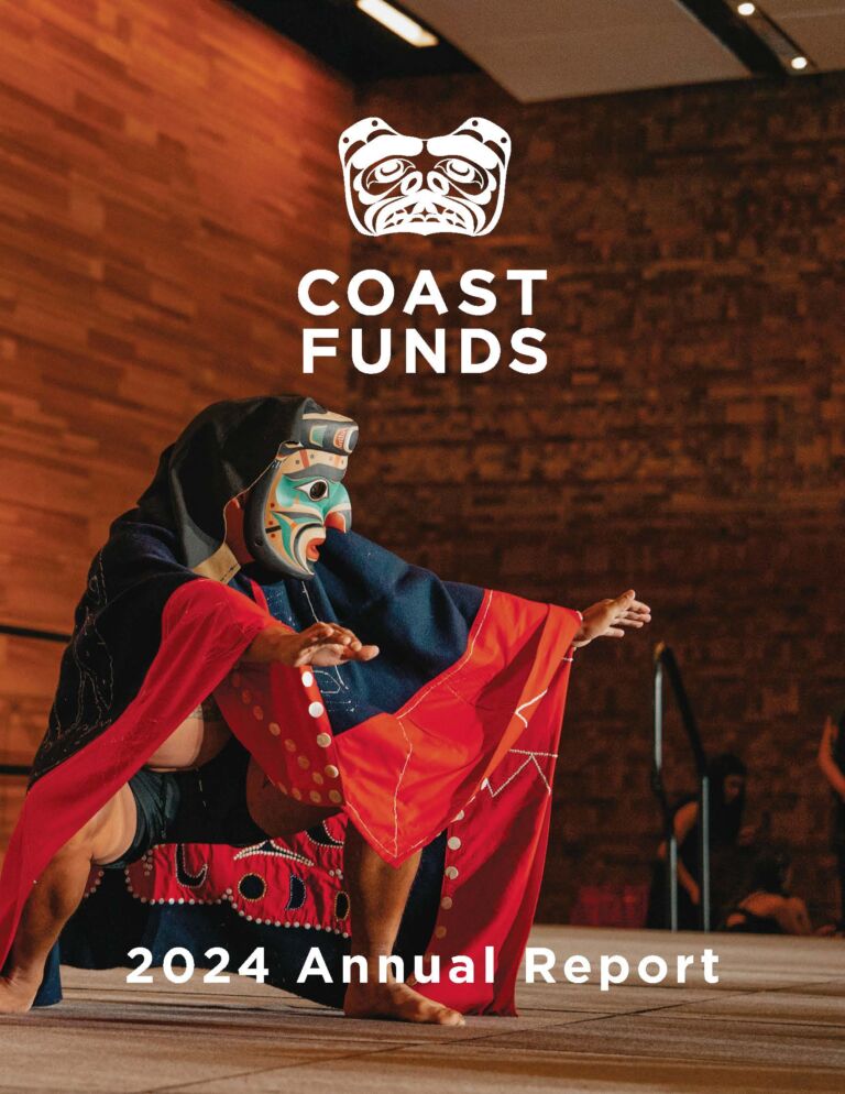 The cover image for the Coast Funds 2024 Annual Report shows a First Nations person dressed in regalia performing at a ceremony. Their regalia is a mix of bright reds, deep blues and black. They are wearing a large mask that is painted with a kaleidoscope of teal, blue, orange, red, and black.