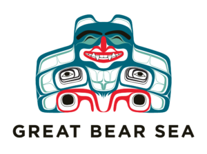 The Great Bear Sea logo. The logo is a colourful collage of teal, deep blues, and bright fire red. The logo is a very happy smiling bear in an Indigenous-style design.