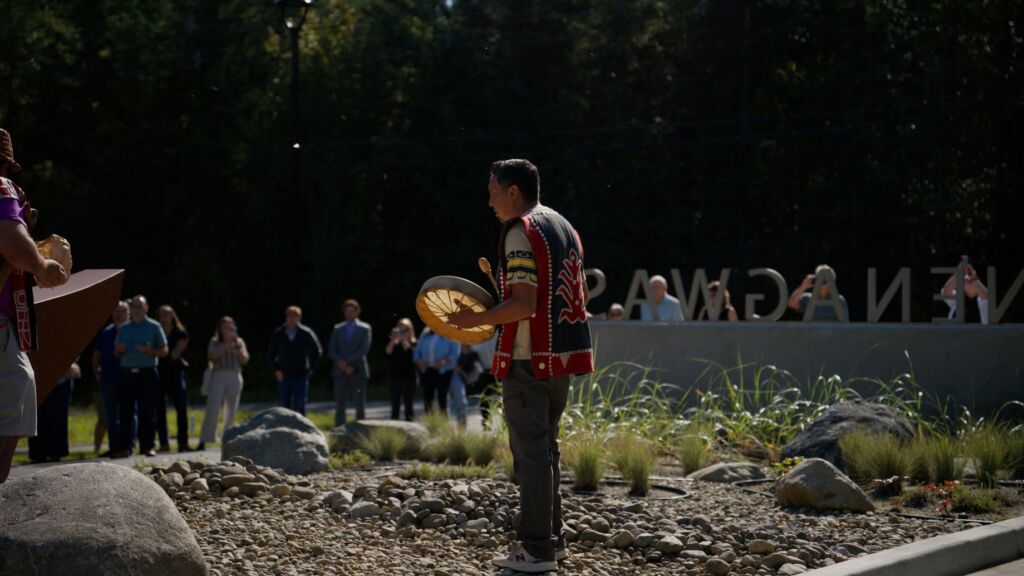 Members of Tlowitsis Nation celebrate the Open House of Nenagwas with a blessing of two canoes at the entrance of the new community space.