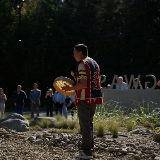 Members of Tlowitsis Nation celebrate the Open House of Nenagwas with a blessing of two canoes at the entrance of the new community space.