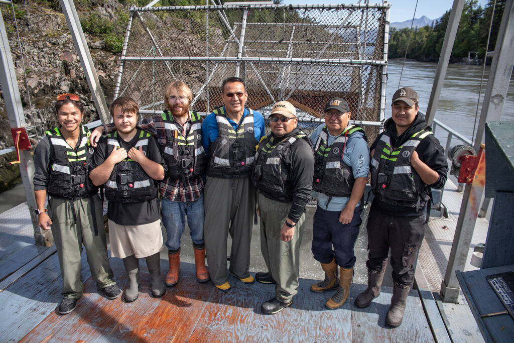 A group photo of the NFWD team standing in front of a fishwheel.