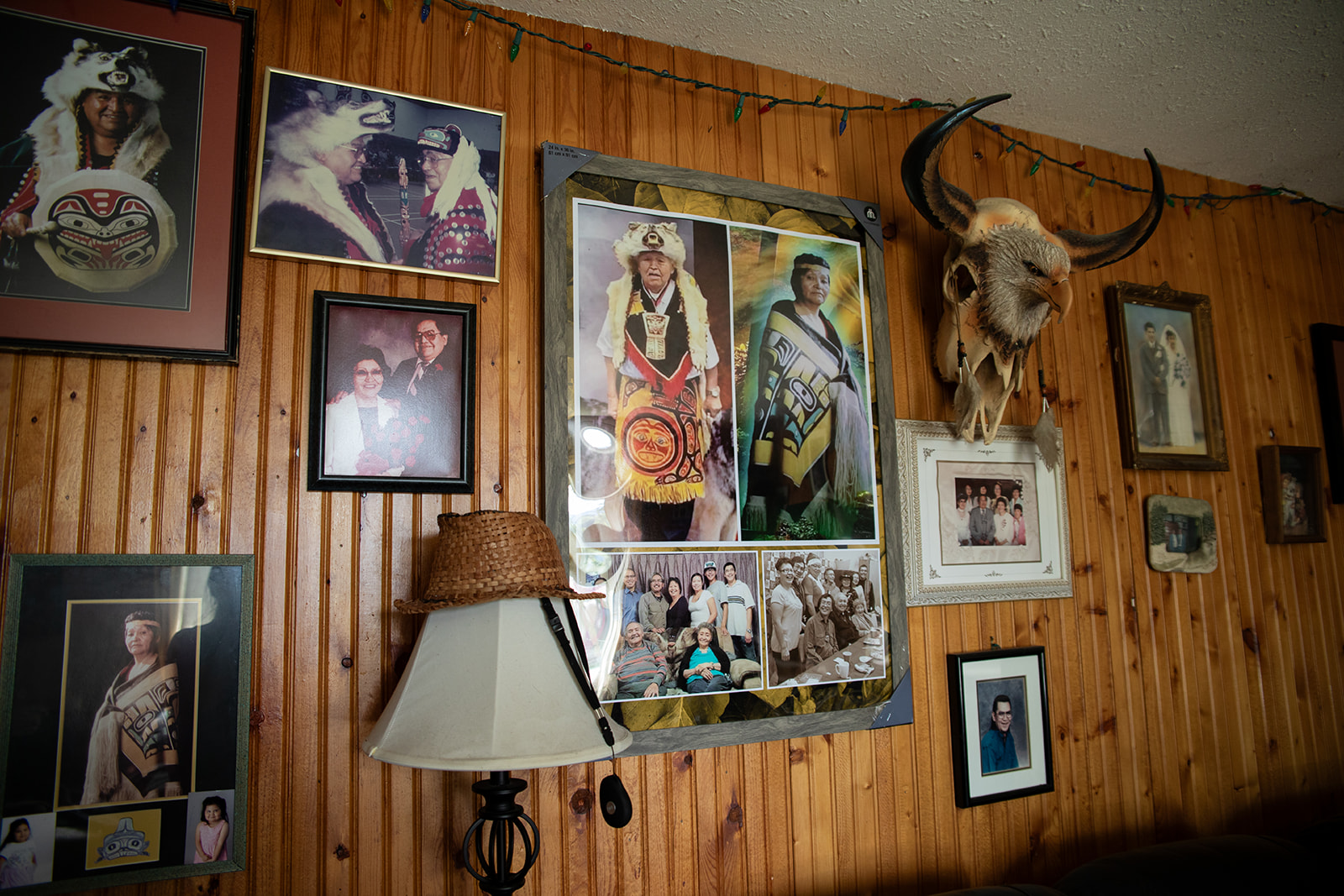 A wall full of photographs in a home.
